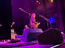 Jeff Hanna singing and playing an acoustic guitar